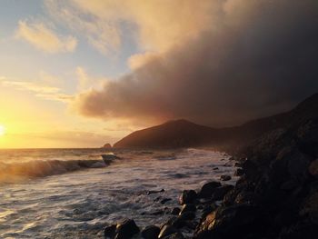 Scenic view of sea against cloudy sky