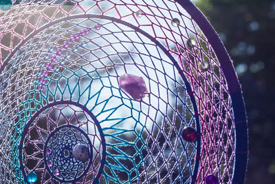 Low angle view of ferris wheel in cage