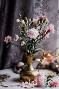 Close-up of pink flowers vase on table