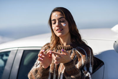 Portrait of woman holding smart phone in car