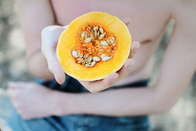 Close-up of hand holding pumpkin