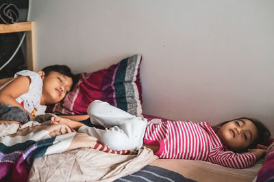 Girl and boy lying on bed