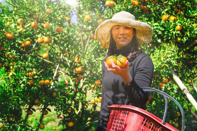 Full length of a smiling young man holding basket