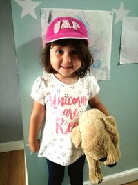 Portrait of cute girl standing at home