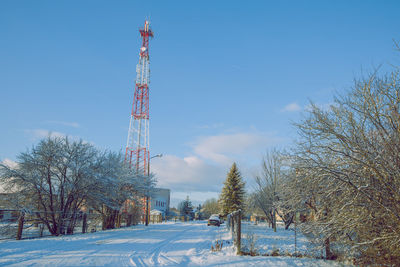 Communications tower against sky during winter