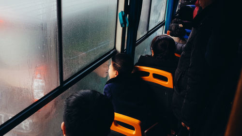 Rear view of people traveling in train