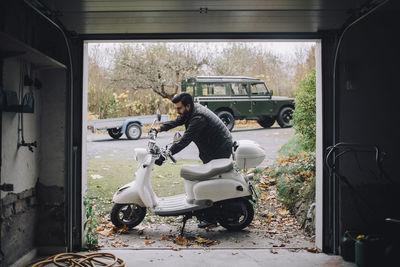 Mid adult man repairing electric motor in garage