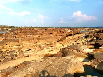 Rock formations on landscape against sky