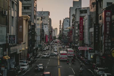 Traffic on road amidst buildings in city