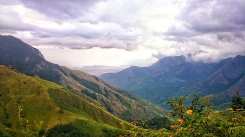 Scenic view of mountains against cloudy sky