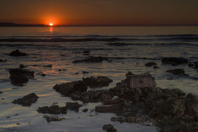 Scenic view of beach against sky during sunset