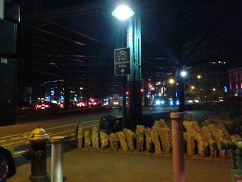 View of illuminated street lights at night