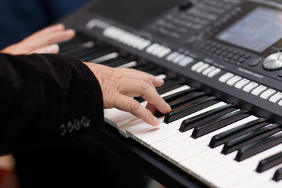 Close-up of man playing piano