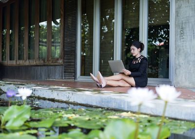 Beautiful businesswoman in black working on laptop . comfortable work or remote work concept.
