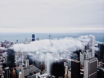 Clouds over city against sky