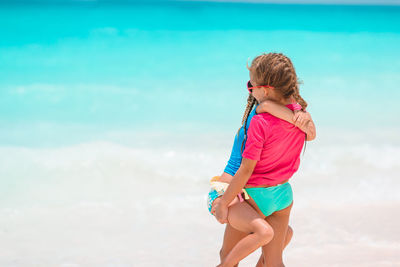Full length of woman on beach against sky