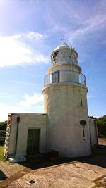 Low angle view of lighthouse on field against sky