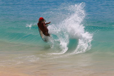 Man surfboarding in river