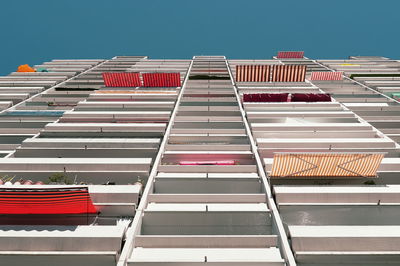 Low angle view of red building against clear blue sky