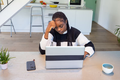 Side view of man using digital tablet while standing in office