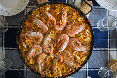 Top view of a paella with prawns