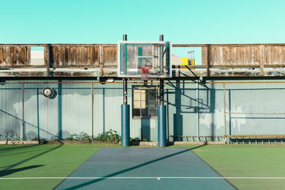 Soccer field by building against sky