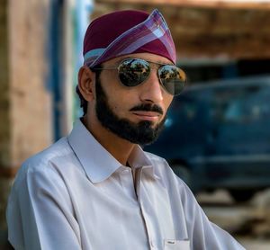 Man wearing black sunglasses and headscarf