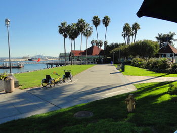 Walkway by sea against clear sky