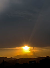 Scenic view of silhouette mountains against sky during sunset