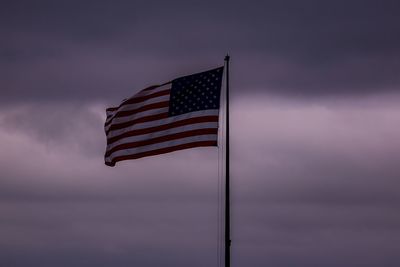 American flag against sky during sunset