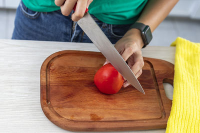 Midsection of man preparing food on cutting board