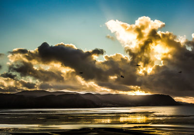 Scenic view of mountains against sky at sunset