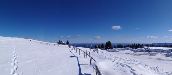 Snow covered land against sky