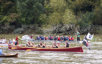 Group of people in boat by river