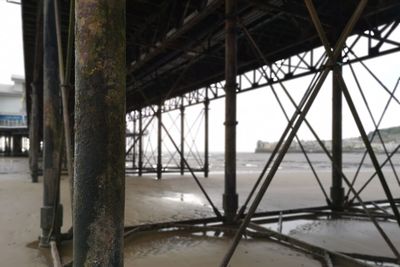 Silhouette of bridge on pier over river