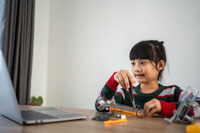 Boy playing with toy at home