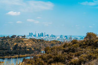 Panoramic view of trees and buildings against sky