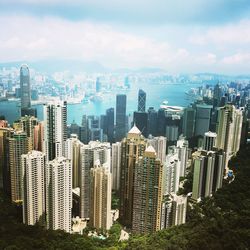 Aerial view of buildings in city against sky