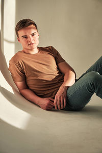 Handsome young man in t-shirt and jeans alone