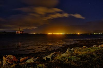 Scenic view of sea against sky at night