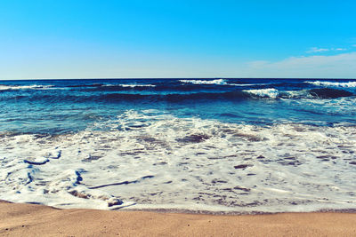 Scenic view of sea against clear blue sky