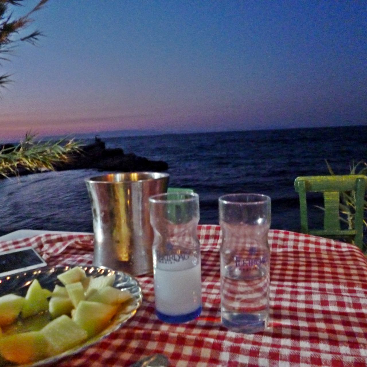 food and drink, table, fruit, sea, food, water, horizon over water, healthy eating, outdoors, drinking glass, tablecloth, plate, no people, beach, freshness, slice, day, picnic, drink, clear sky, nature, sky, ready-to-eat