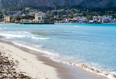 Scenic view of beach by buildings