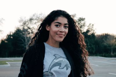 Portrait of smiling teenage girl at park