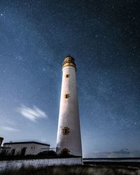 Low angle view of lighthouse against starry sky at night