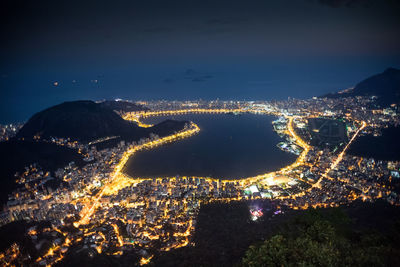 High angle view of city lit up at night