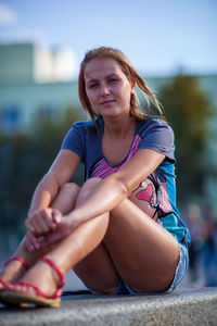 Young woman sitting outdoors