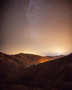 Scenic view of mountains against sky at night