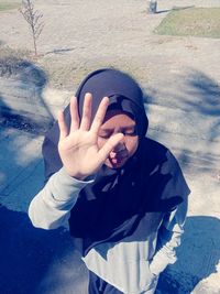 High angle view of man covering face with hand