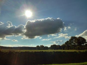 Scenic view of landscape against cloudy sky